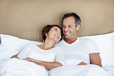 Buy stock photo Love, relax and care with couple in bedroom in home for wake up, connection and romantic partner. Bonding, support and morning with man and woman in bed in apartment for trust, marriage and smile