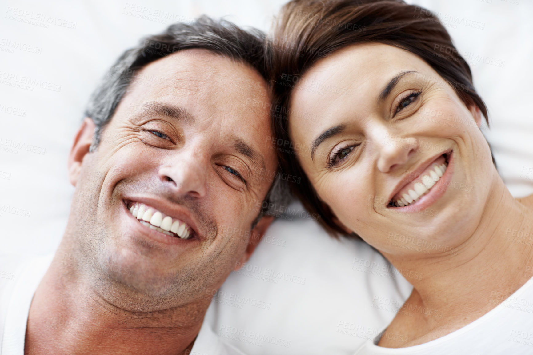 Buy stock photo Love, portrait and above with couple in bedroom in home for wake up, connection and romantic partner. Bonding, support and morning with mature man and woman in bed in apartment for trust and care