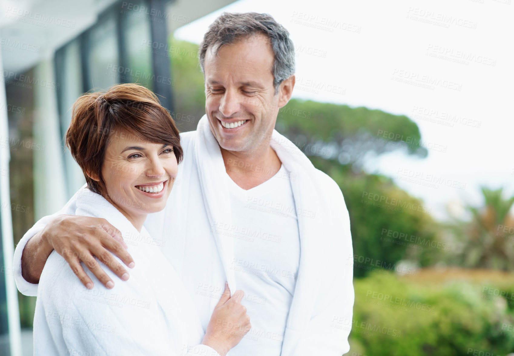 Buy stock photo Love, smile and balcony with couple at hotel for travel, anniversary getaway and bonding. Marriage, holiday villa and hospitality with man and woman relax at resort for view, space and support