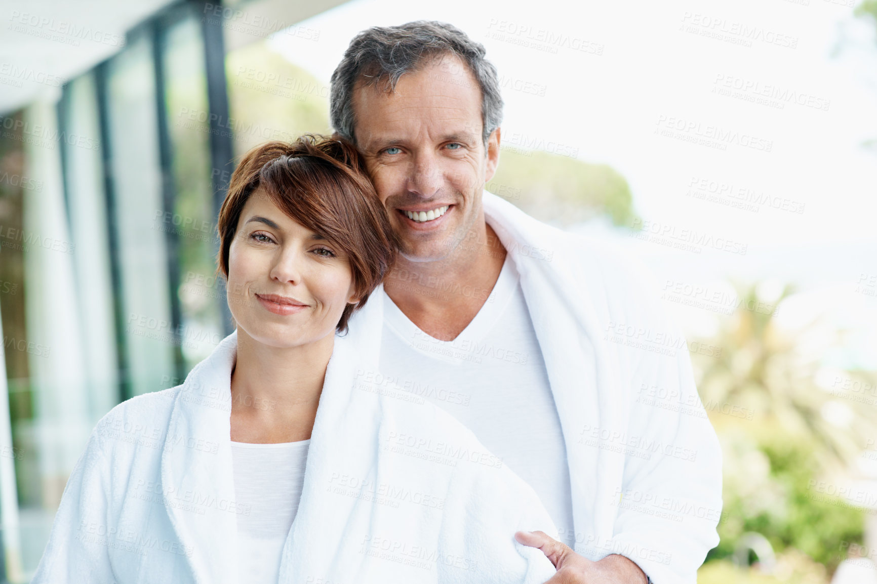 Buy stock photo Portrait, couple and relax at hotel with smile, affection and bonding together at holiday resort. Happy, people and love at accommodation, healthy relationship and connection for anniversary vacation