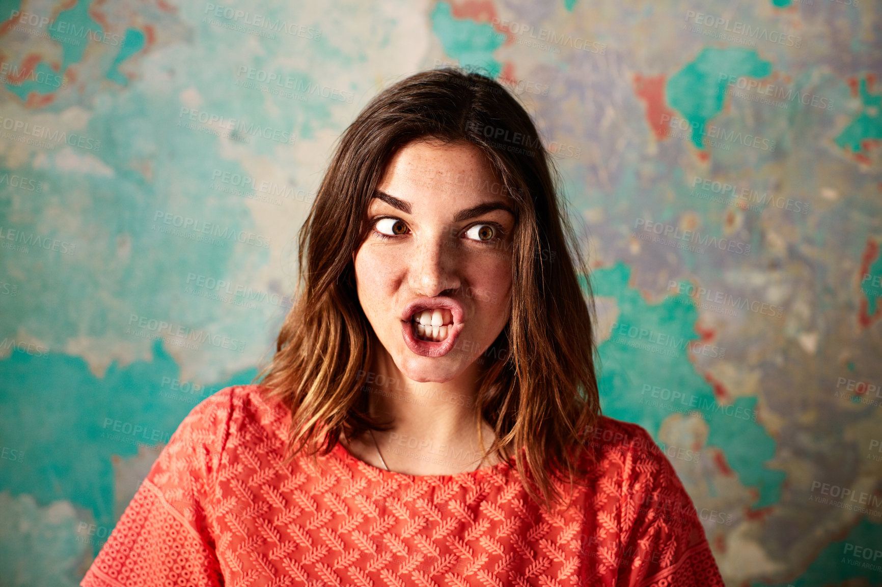 Buy stock photo Character, woman and silly face on damaged wall for theater improvisation or acting class. Female person, student or hush with goofy expression on weathered or peeling background for school play