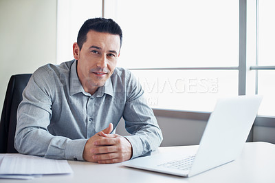 Buy stock photo Portrait of a businessman sitting   with a laptop at his office desk