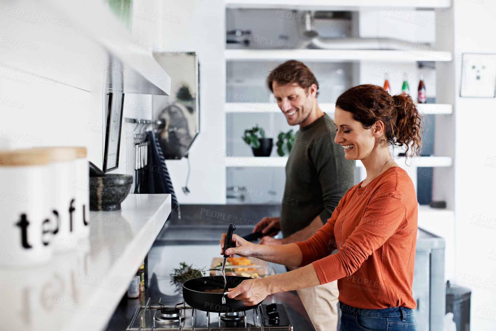 Buy stock photo Help, couple and happy woman in kitchen with cooking, funny conversation and healthy marriage. Food, people and laughing in house with meal prep, dinner support and culinary hobby with bonding chat