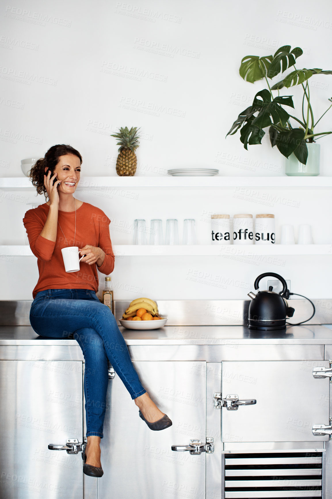 Buy stock photo Kitchen, happy and woman with coffee for phone call, conversation and talking for gossip. Home, morning and person with drink, cellphone and smile for listening, communication and chat for connection