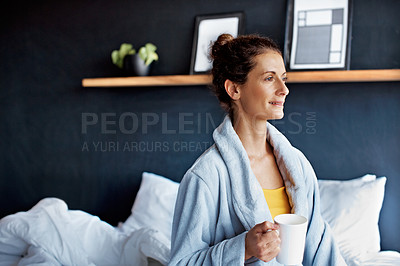 Buy stock photo Shot of a mature woman sitting in bed drinking a coffee
