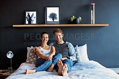 Buy stock photo Portrait of a content mature couple sitting on their bed together
