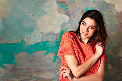 Buy stock photo Shot of a smiling young woman standing in front of a a peeling wall