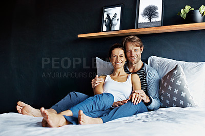 Buy stock photo Portrai of a smiling couple lying in bed together