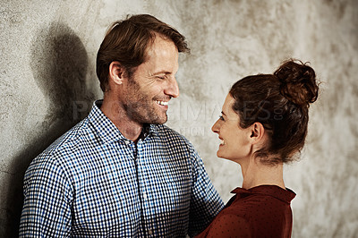 Buy stock photo Shot of a affectionate mature couple standing face to face and laughing