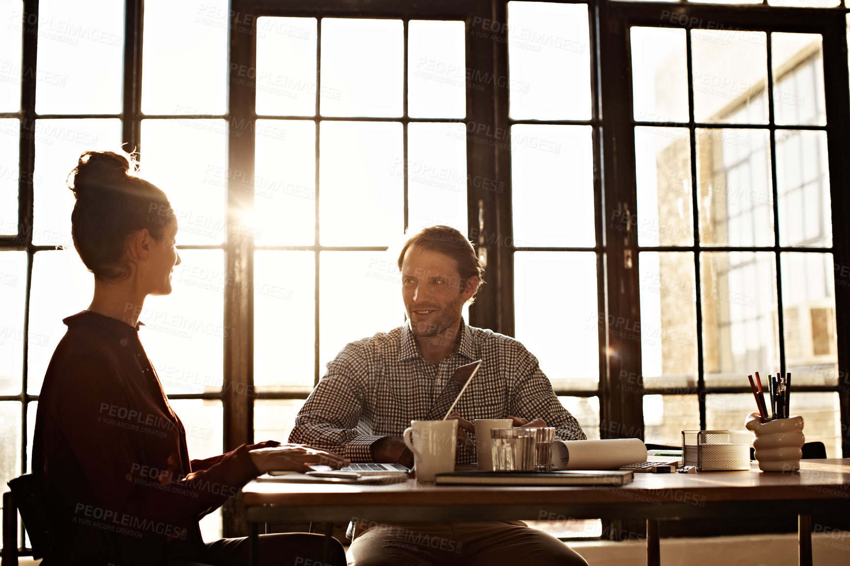 Buy stock photo Shot of a couple working at their dining table