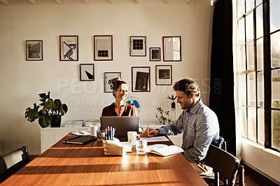 Buy stock photo Shot of a couple working at their dining table