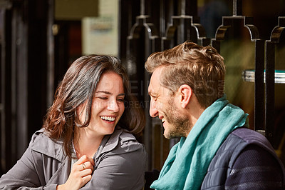 Buy stock photo Shot of a smiling couple sitting together at a table at a sidewalk cafe