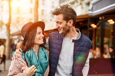 Buy stock photo Shot of a smiling young couple walking together in the streets of Paris