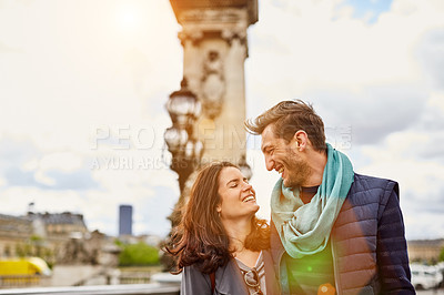 Buy stock photo Shot of a smiling young couple walking together in the streets of Paris