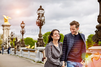 Buy stock photo Shot of a smiling young man standing on a bridge over the Seine River in Paris