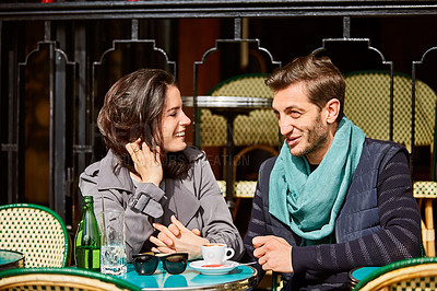 Buy stock photo Shot of a smiling couple sitting together at a table at a sidewalk cafe