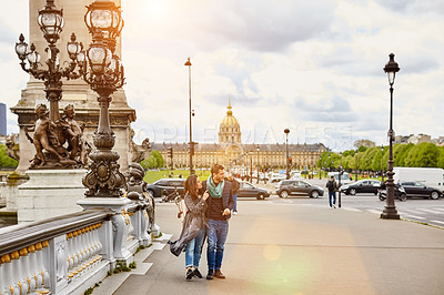 Buy stock photo Shot of a smiling young couple walking together in the streets of Paris
