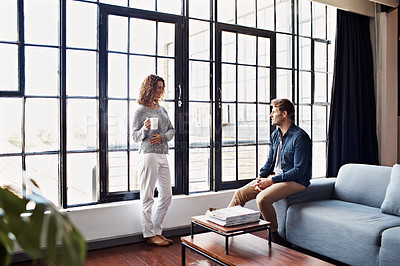 Buy stock photo Shot of a mature couple relaxing together in their living room at home