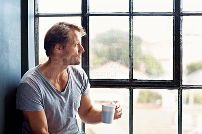 Buy stock photo Shot of a mature man sitting on a window sill at home drinking a cup of coffee