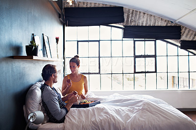 Buy stock photo Shot of a smiling mature couple enjoying breakfast in bed together in the morning