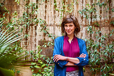 Buy stock photo Portrait of a young woman standing outside in her back patio