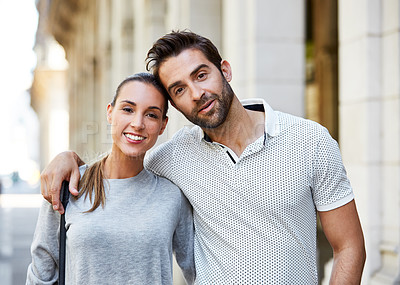 Buy stock photo Portrait of an affectionate young couple standing together in the city