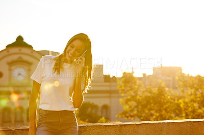 Buy stock photo Portrait of an attractive young woman leaning on a wall with the city in the background