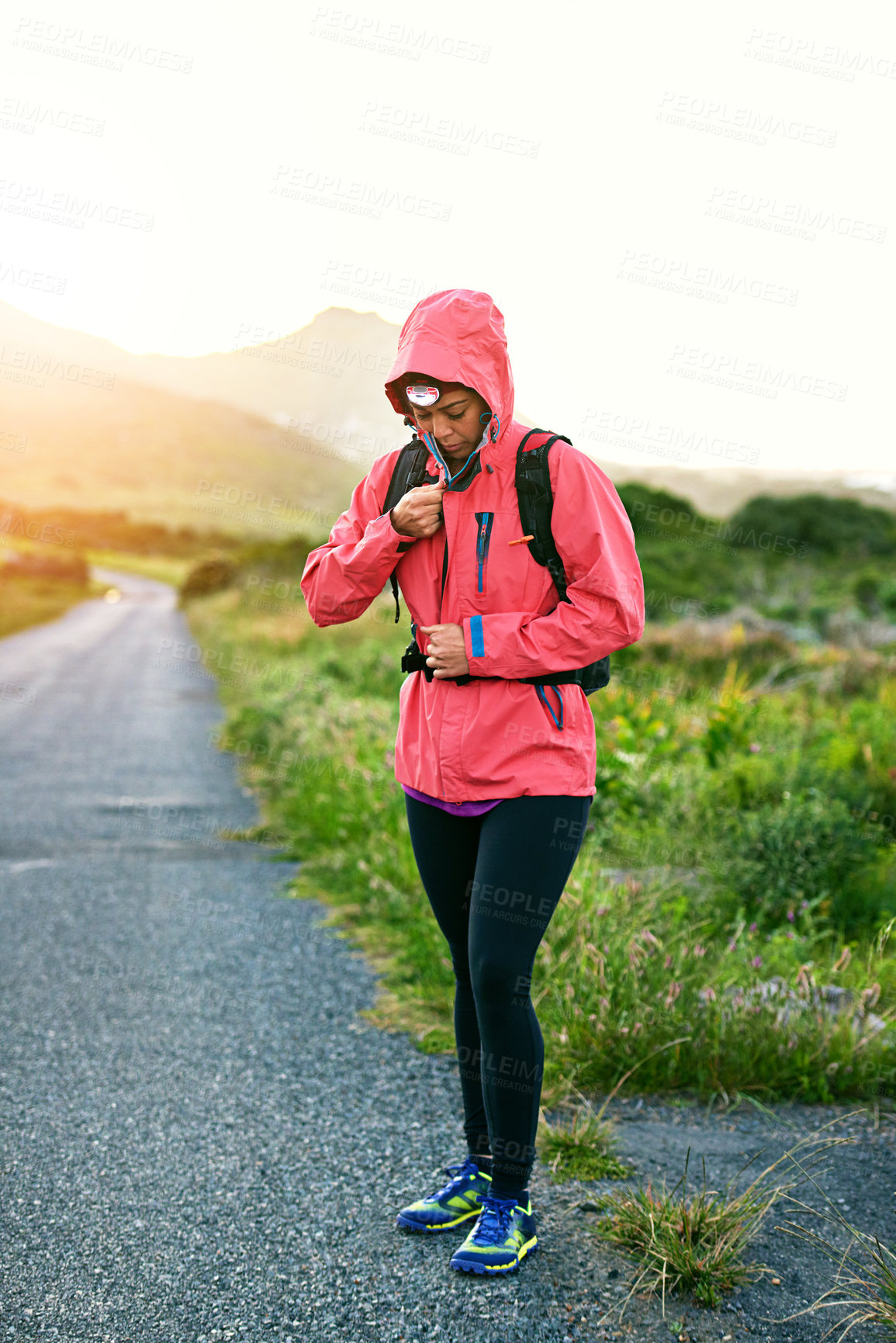 Buy stock photo Shot of a young woman preparing for a run on a cool morning