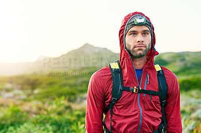 Buy stock photo Shot of a focused young man out for a run on a cool morning