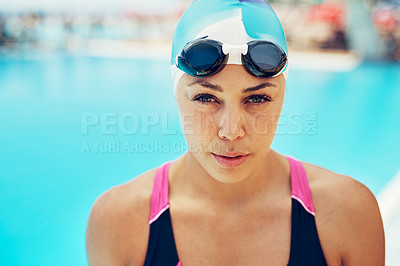 Buy stock photo Portrait of an athletic young woman in swimming goggles standing by the edge of a swimming pool