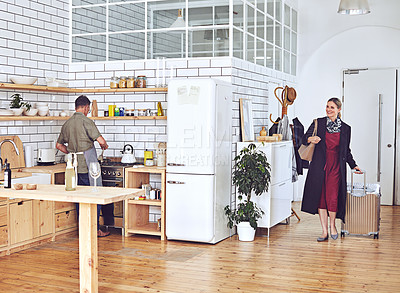 Buy stock photo Shot of a mature woman arriving home to her husband cooking in the kitchen
