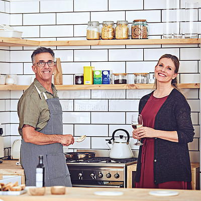 Buy stock photo Shot of an affectionate mature couple cooking together in the kitchen