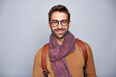 Buy stock photo Studio portrait of a handsome young man posing against a gray background