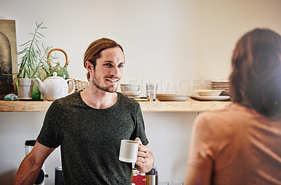 Buy stock photo Shot of an affectionate young couple having a conversation in the kitchen
