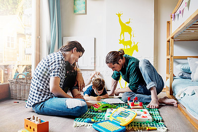 Buy stock photo Shot of a young family of three drawing while sitting on the floor of a child's bedroom
