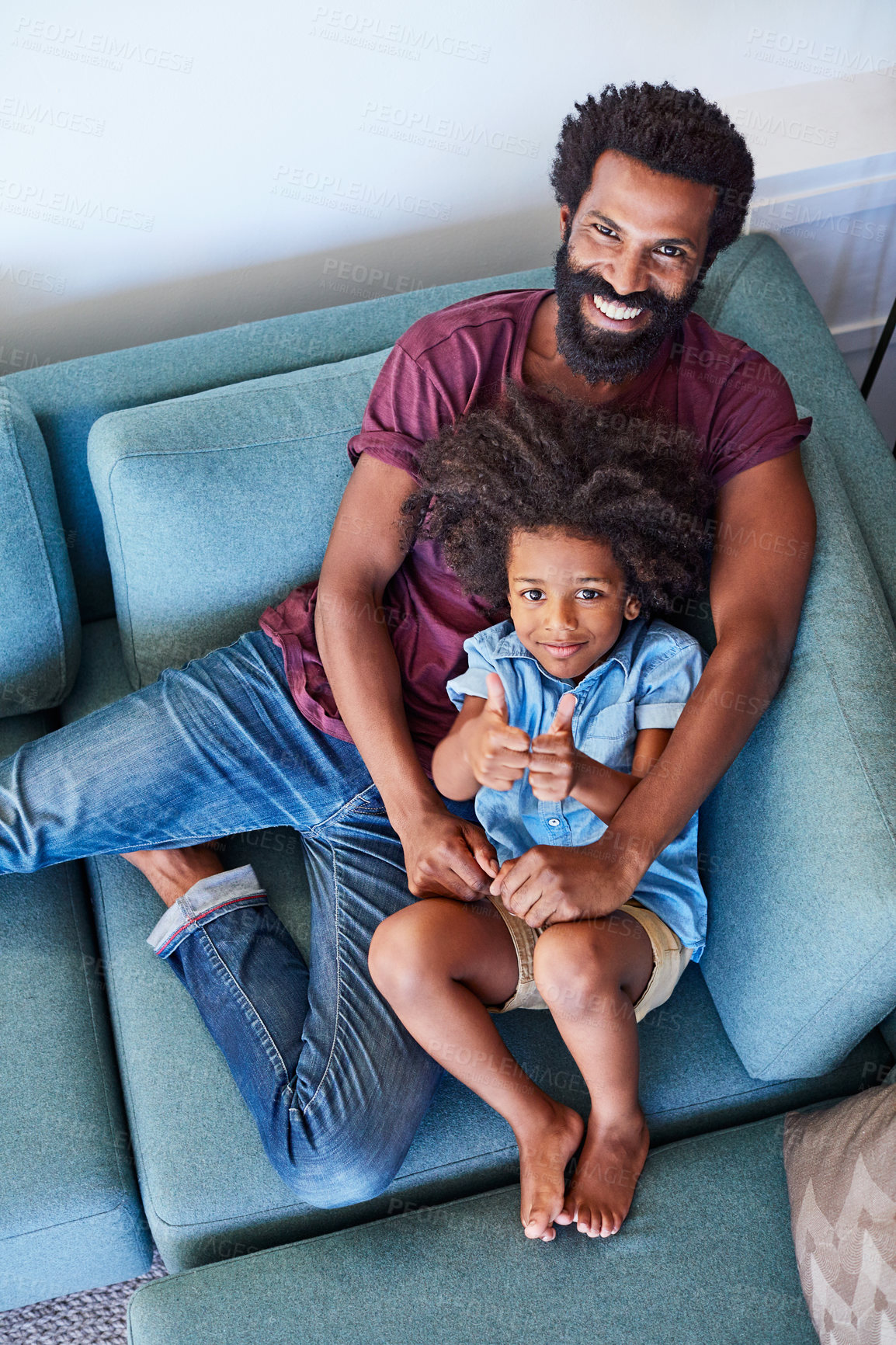 Buy stock photo Portrait, thumbs up and father with son on sofa in home for weekend break, support and bonding. Love, connection and care with black man and child in living room of family house for trust and above