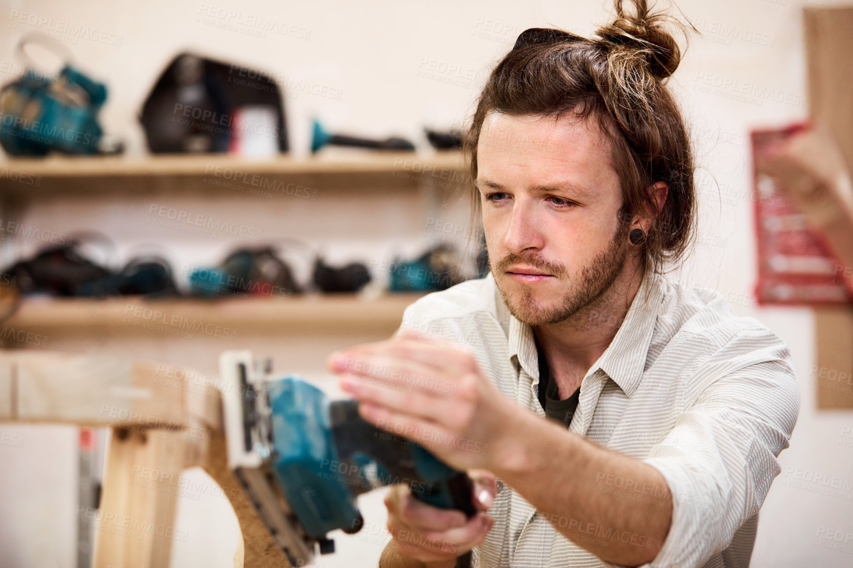 Buy stock photo Shot of a man working with wood in a furniture manufacturing workshop