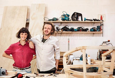 Buy stock photo Shot of two people working with wood in a furniture manufacturing workshop
