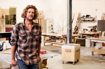 Buy stock photo Portrait of a handsome young man standing in a furniture manufacturing workshop