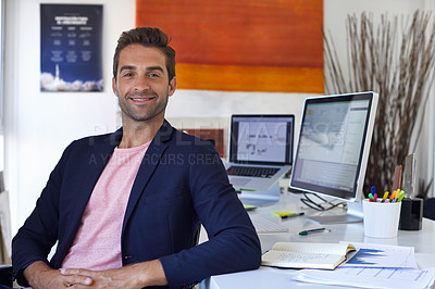 Buy stock photo Portrait of a handsome businessman sitting at his desk