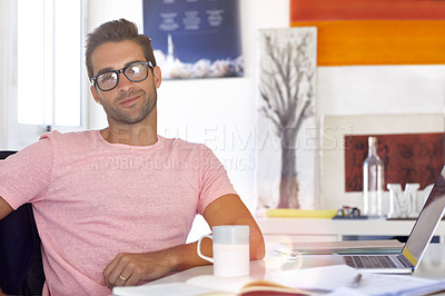 Buy stock photo Portrait of a handsome businessman sitting at his desk