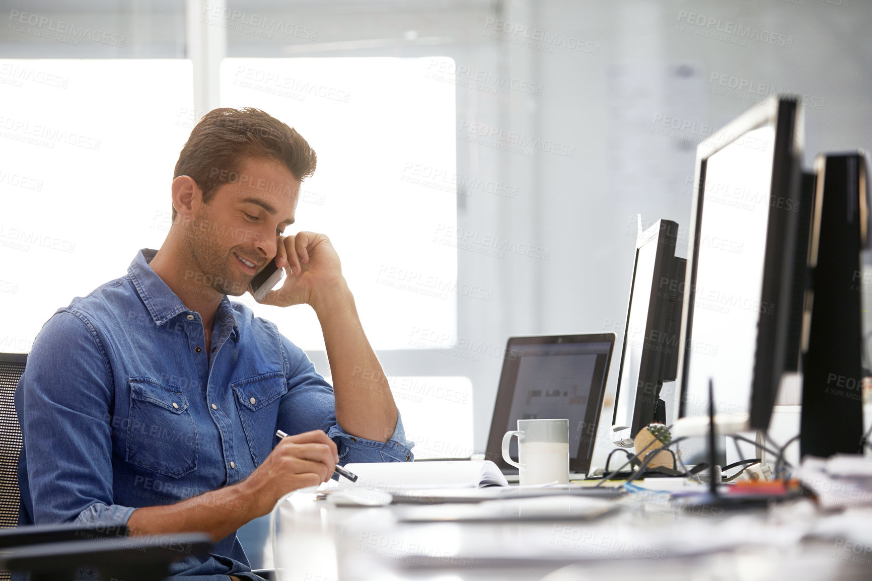 Buy stock photo Shot of a businessman using his cellphone in his office