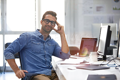 Buy stock photo Portrait of a handsome businessman sitting at his desk
