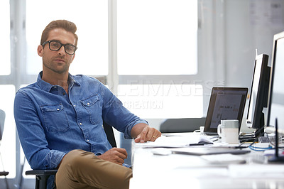 Buy stock photo Portrait of a handsome businessman sitting at his desk