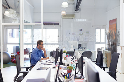 Buy stock photo Shot of a businessman working on his computer