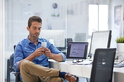 Buy stock photo Shot of a businessman using his cellphone in his office