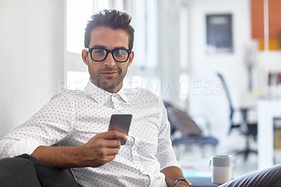 Buy stock photo Shot of a businessman using his cellphone in his office