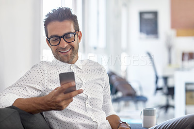 Buy stock photo Shot of a businessman using his cellphone in his office