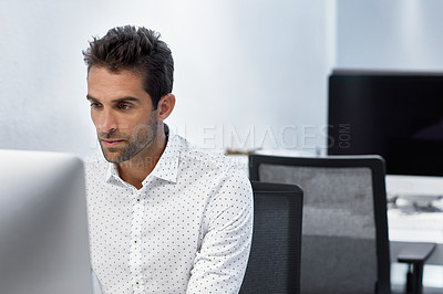 Buy stock photo Cropped shot of a businessman working on his computer
