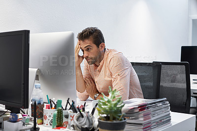 Buy stock photo Cropped shot of a businessman looking stressed while sitting at his desk